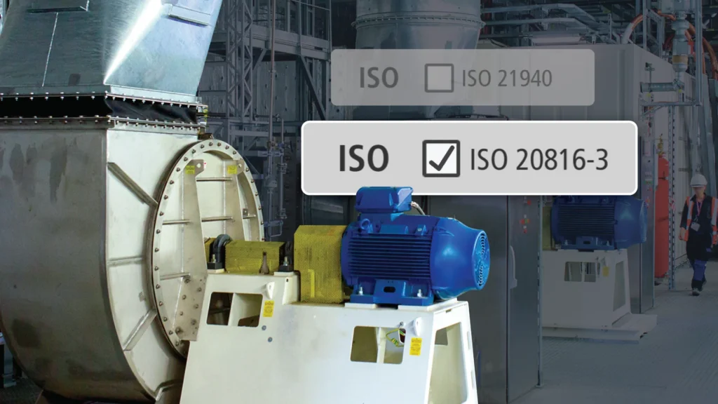 Industrial machinery factory scene with an on-screen overlay showing ISO 20816-3 and a checked box (certification status).