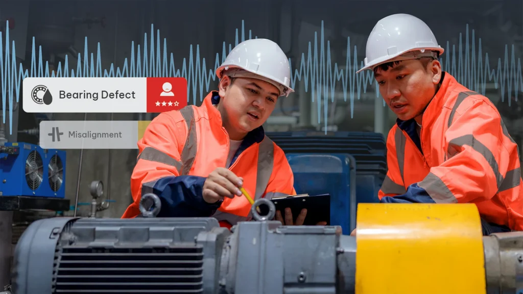 Two industrial workers in orange safety gear inspect machinery; overlay icons indicate bearing defect and misalignment.